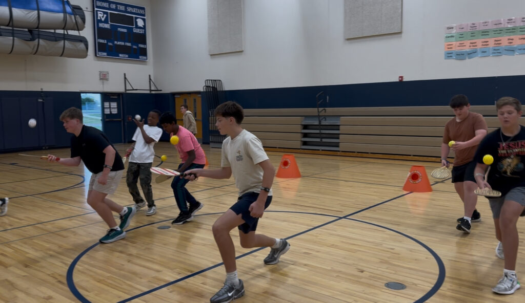 Kids using heart rate monitors for school while in PE class